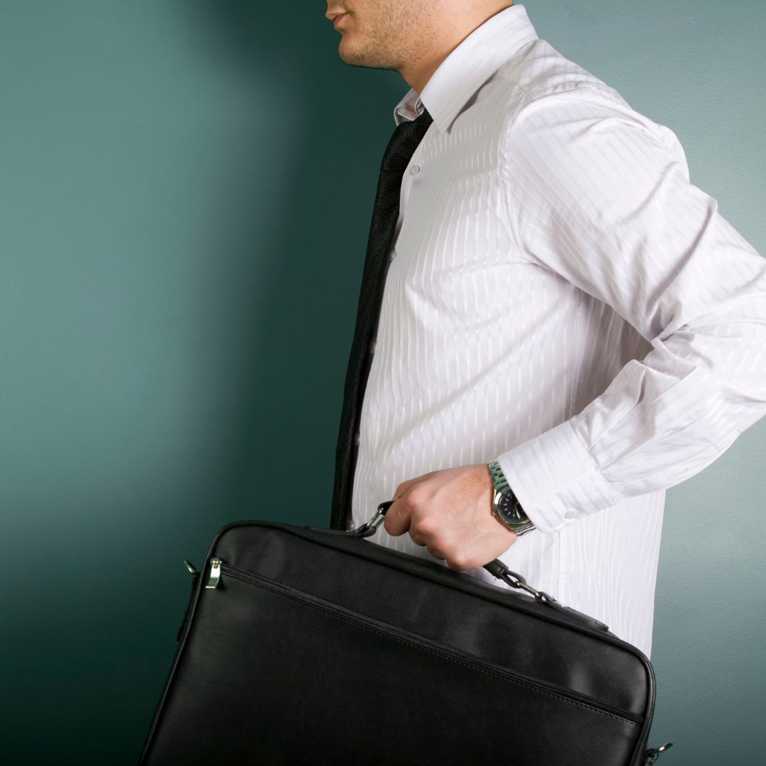 person carrying laptop briefcase