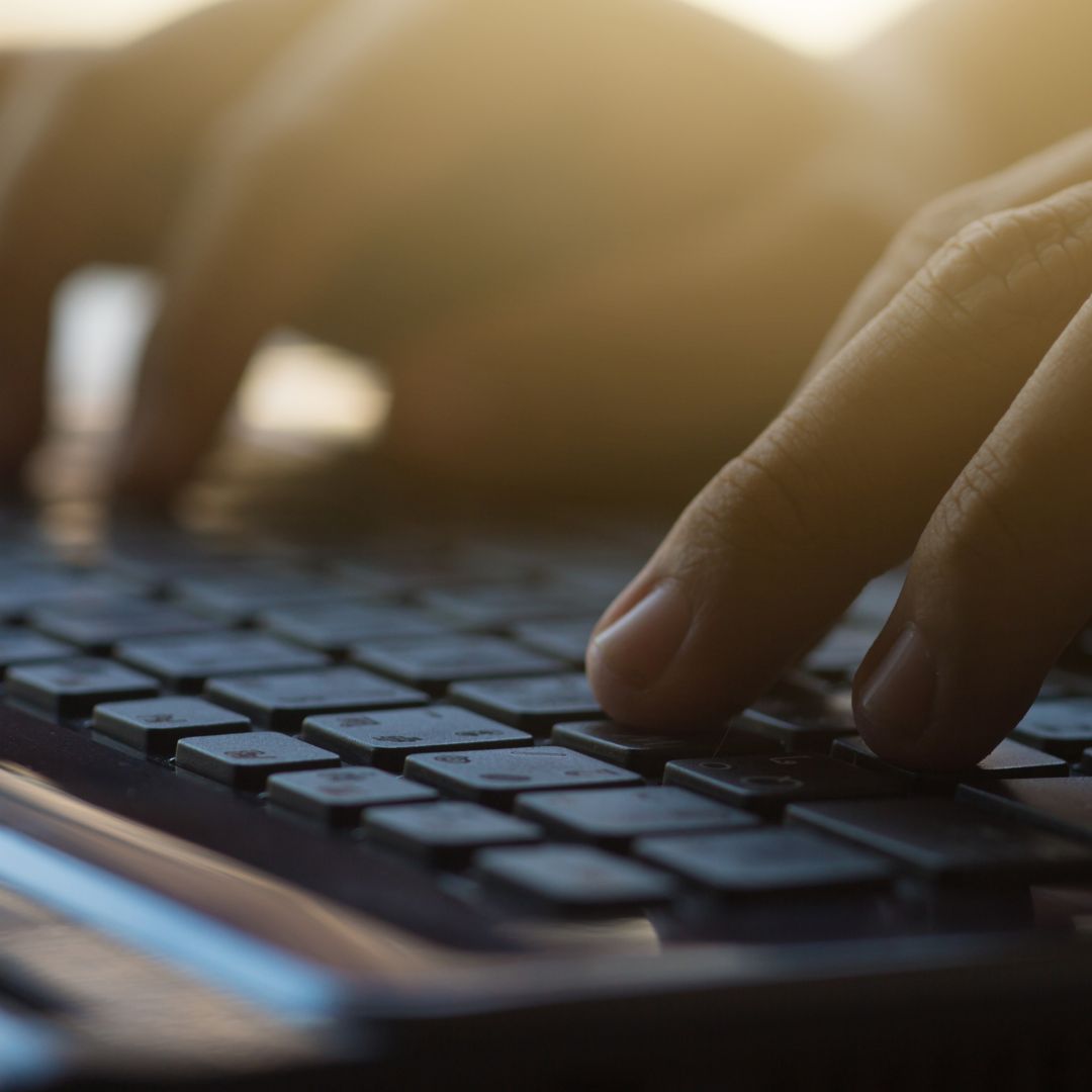 person typing on keyboard