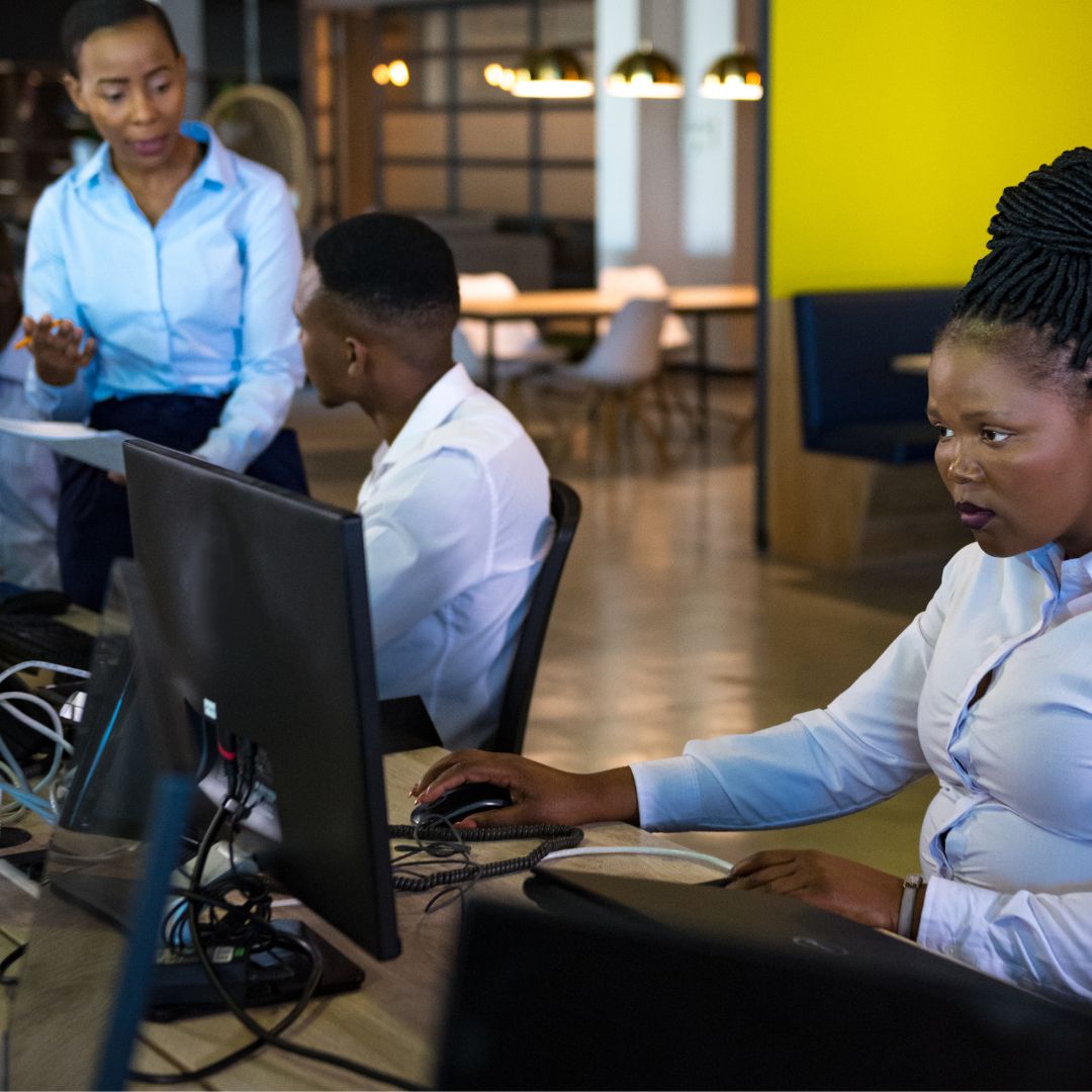 people working on desktop computers